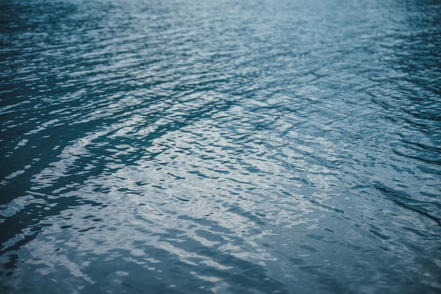 Texture of purple calm water of mountain lake.