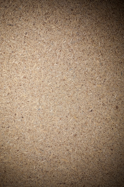 Texture recycled compressed wood chippings board background.