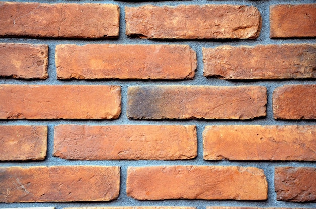 Texture of red burnt brick close up background