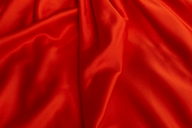 Texture of red satin fabric closeup Silk or satin material Textile background Plain bright cloth