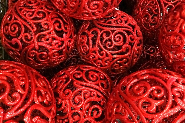 texture red shiny patterned Christmas new year tree toys balls, decorations for the Christmas tree. close-up, soft focus.