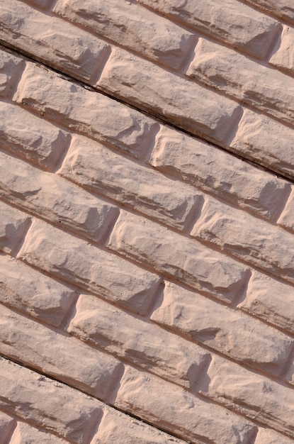 Texture of a relief concrete wall of beige color