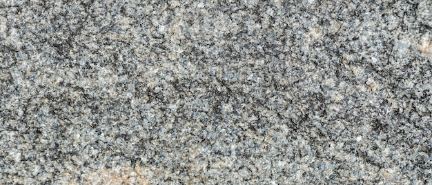 Consistenza della superficie rocciosa. trama di granito come sfondo della natura. granito grigio naturale con un motivo granuloso