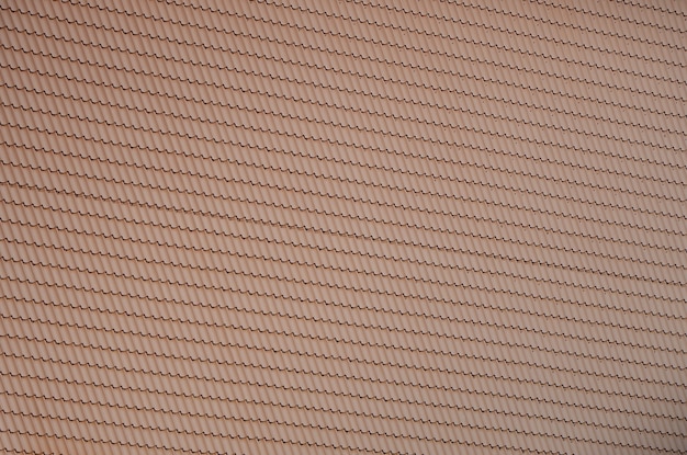 The texture of the roof of painted metal. Close-up detailed view of roof covering for pitched roof.