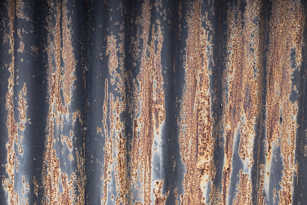 The texture of rusty wavy metal with black paint