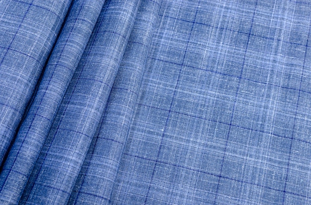 Текстура шелковой ткани в сине-голубую клетку. Фон, узор