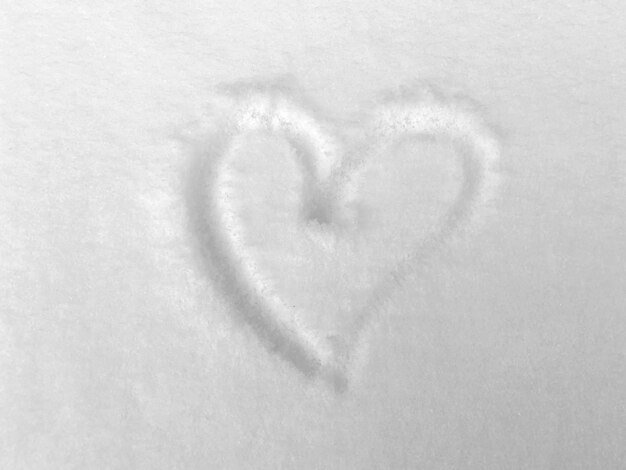 The texture of the snow and a heart drawn on the snow