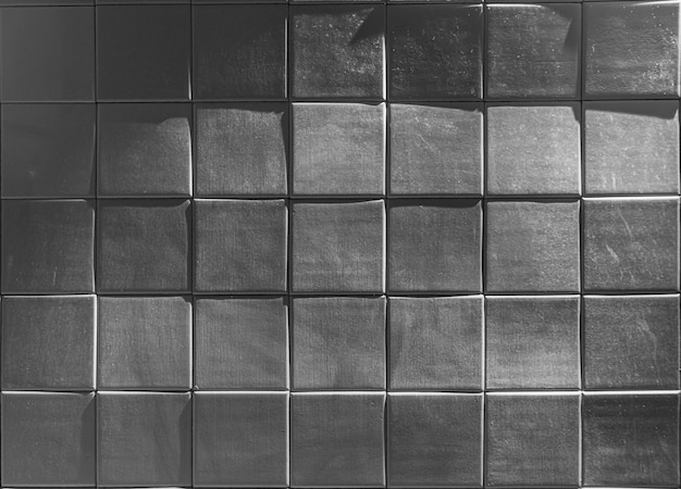 The texture of square glossy uneven ceramic tiles Hard dark lighting