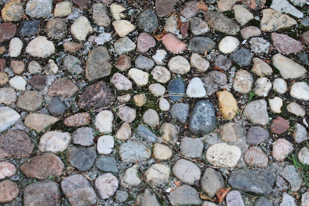 Texture of stone old masonry cobblestone pavement