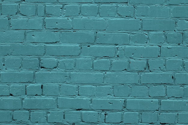 Texture of a turquoise brick wall. Green stone background.