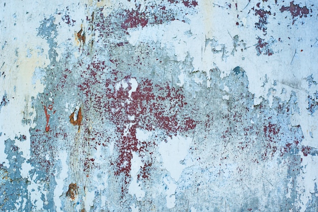 Photo texture of vintage rusty gray iron wall background with many layers of paint and rust