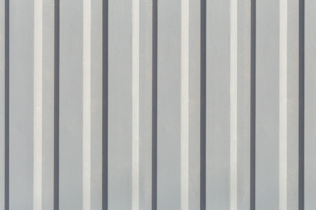 Texture of the wall with gray vertical siding panels in strips with copy space