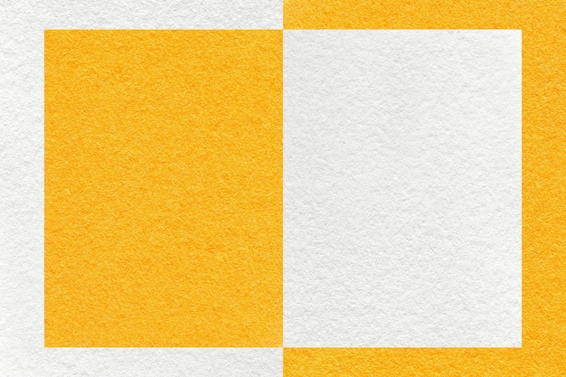 Texture of white and bright yellow paper background with geometric shape and pattern macro Craft orange cardboard