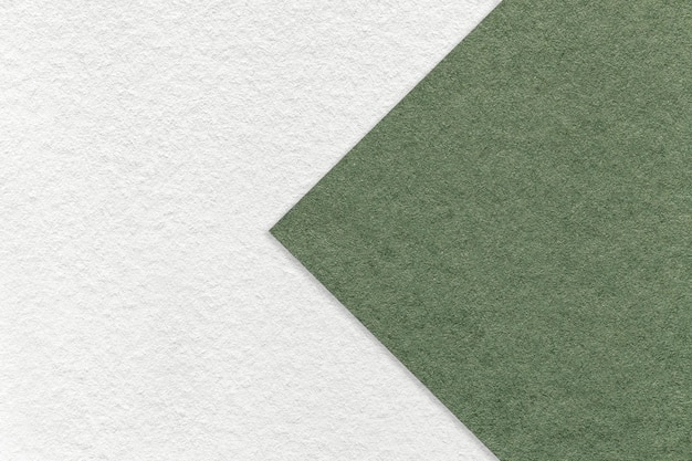 Texture of white paper background half two colors with green arrow macro Structure of dense craft olive cardboard