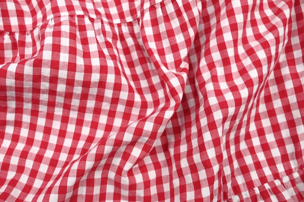 Texture of white-red crumpled fabric in a cage. 