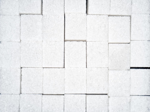 Texture of white sugar cubes closeup