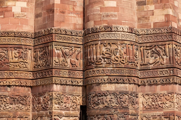 Texture with pattern of red sandstone tower of Qutub Minar in New Delhi India