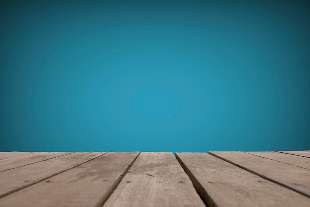 Texture of wooden boards floor The empty part of the blue cement wall