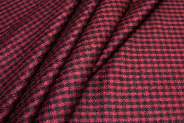 Photo texture of woolen fabric in burgundy color. goose foot.