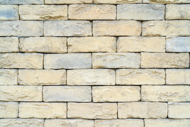 Photo texture of yellow brick made of sandstone and limestone. the wall of the house.