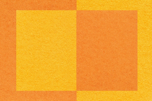 Texture of yellow and orange paper background with geometric pattern macro Structure of craft cardboard with frame