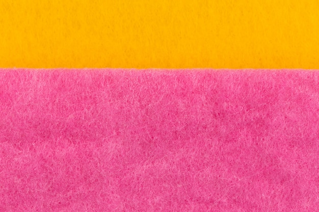 Texture of yellow pink washcloths macro close-up background with close range.