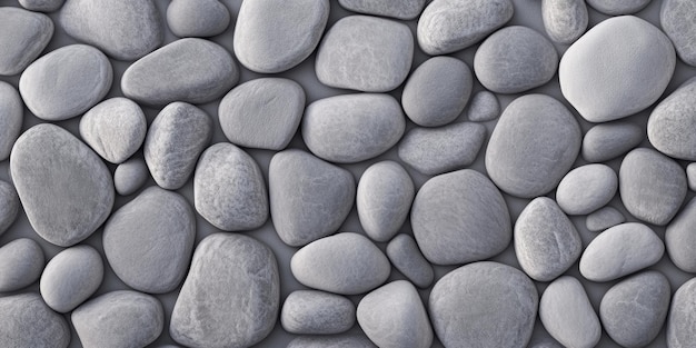 A textured arrangement of smooth gray stones set on a flat surface in natural light highlighting their subtle variations and forms