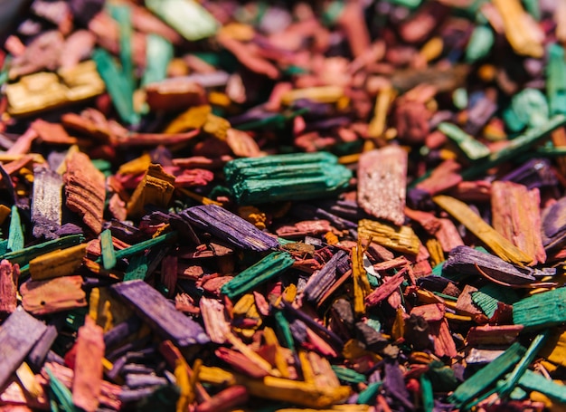 Textured background of decorative colored sawdust for finishing
flower beds green burgundy yellow red and purple sawdust the
texture of small colored wood chips