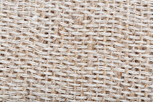 Textured background of fabric from burlap fibers with fibers in full screen. Macro