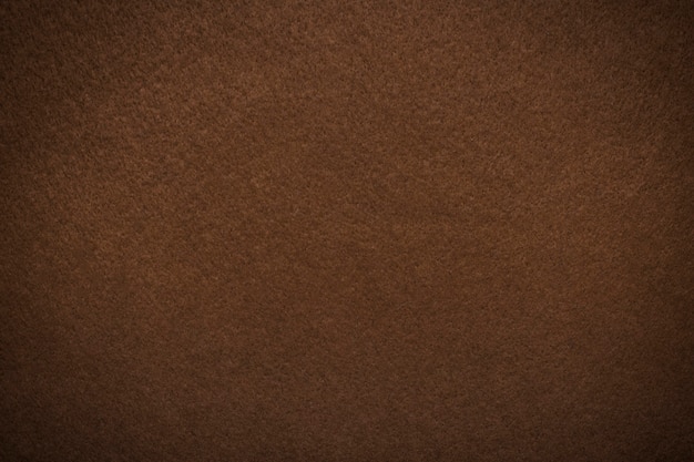 Textured background of felt fiber brown with vignette