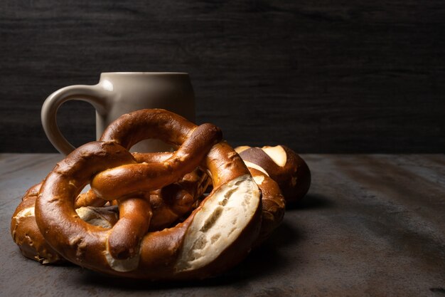 textured background with pretzels and jar of beer oktoberfest