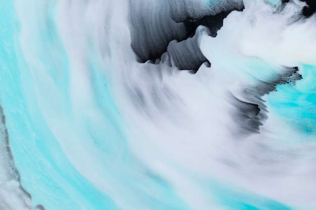Textured brush strokes in black and turquoise color over background