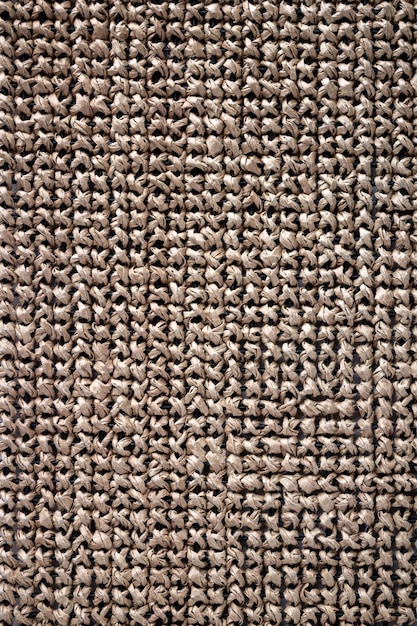 The textured canvas is embroidered with a cross made of raffia paper yarn