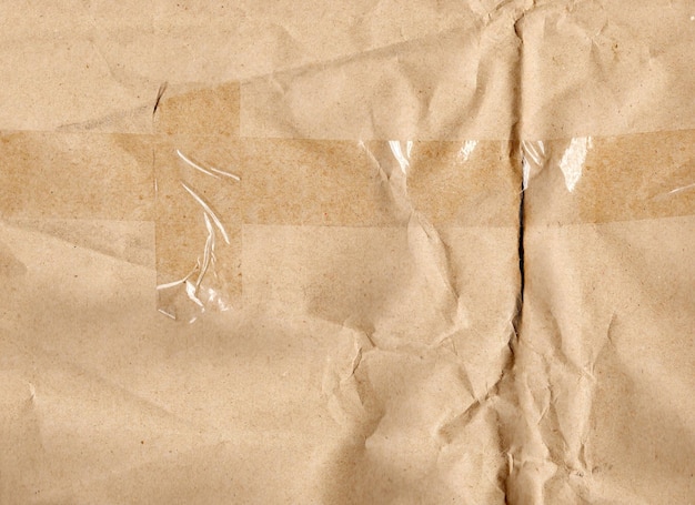 Textured cardboard with a deep wrinkled fold and pasted adhesive tape