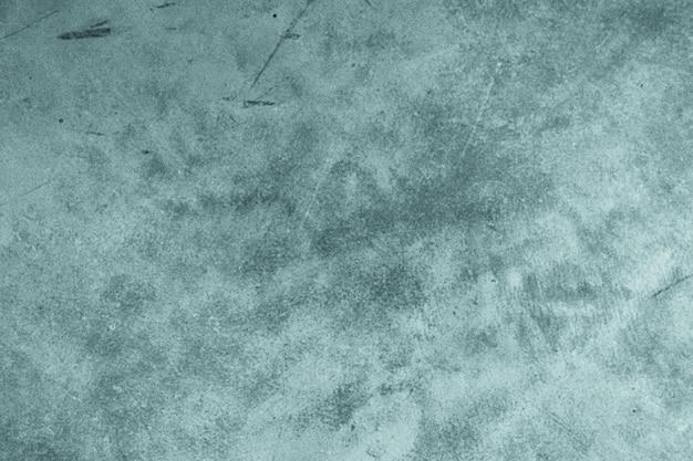 Textured cyan stucco background with scratches scuffs and stains