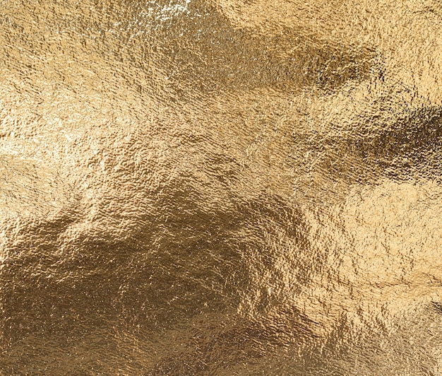 Textured golden foil as background top view