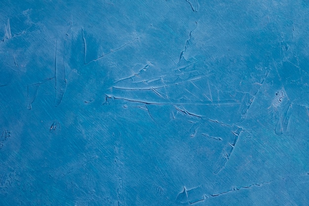 Textured scratched plaster stucco blue background