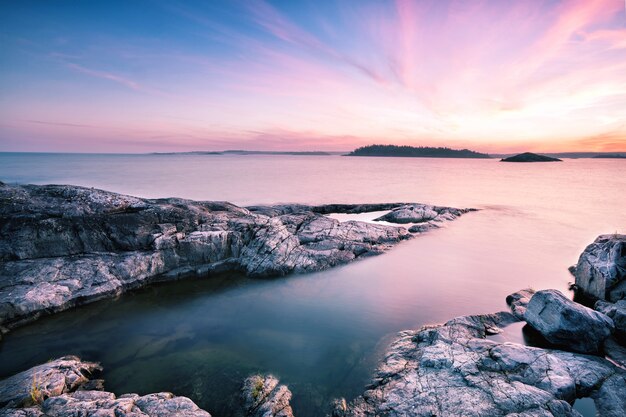 Textured stone island under dawn sky