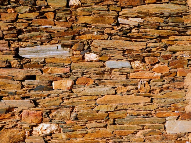 Photo textured stone wall with patterned brick design