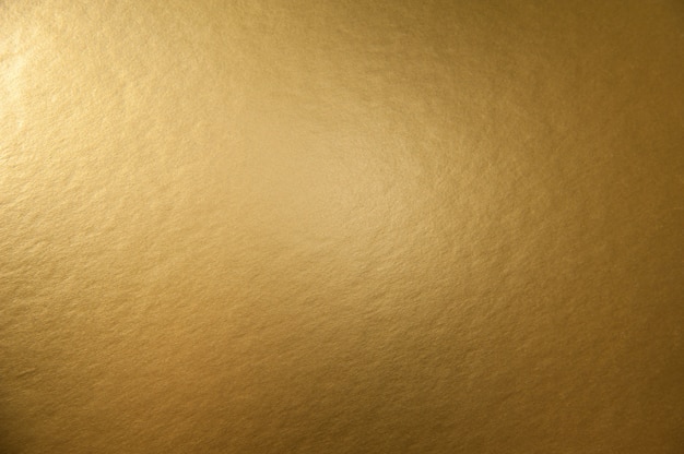 textuur achtergrond van gouden metallic papier oppervlak voor ontwerp Kerstmis of Nieuwjaar feestkaarten