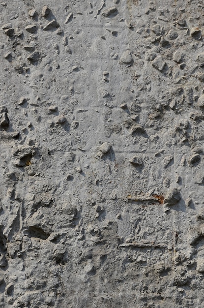 Textuur van de oude in reliëf gemaakte concrete muur in grijze kleur. achtergrond van een concreet product