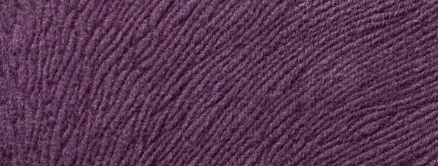 Textuur van donkere violette textielachtergrond van een zachte wollen materiële macro Stof met paars golvend patroon
