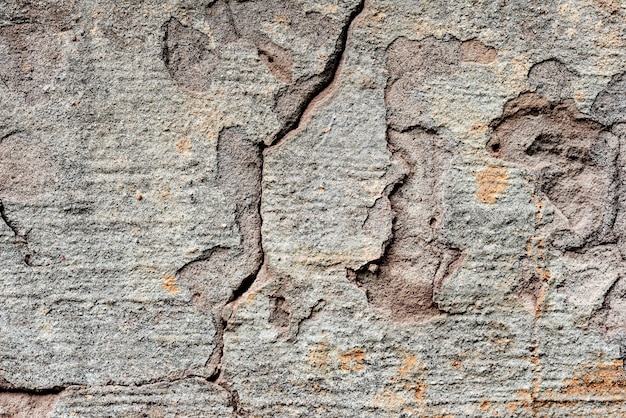 Textuur van een betonnen muur met scheuren en krassen achtergrond