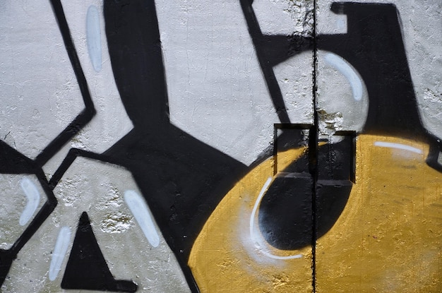 Textuur van een fragment van de muur met graffiti schilderij dat erop is afgebeeld Een afbeelding van een stuk graffiti tekening als een foto over straatkunst en graffiti cultuur onderwerpen
