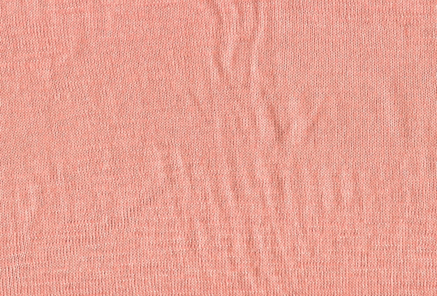 Textuur van een gebreide roze trui behang. Textiel roze materiaal met rieten patroon.