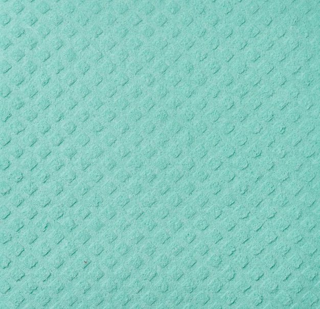 Textuur van groene spons voor keuken en huis op witte geïsoleerde achtergrond