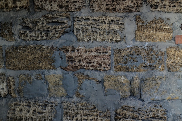 Textuur van natuursteen. achtergrond van shellstone steen. stenen muur met cement
