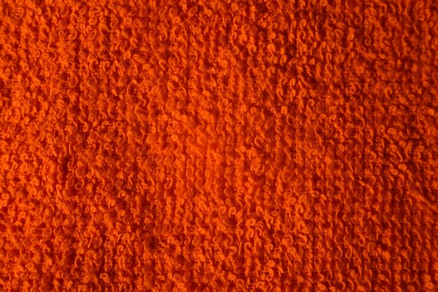 Textuur van oranje gebreide stof macro foto Textiel getextureerde achtergrond Bovenaanzicht close-up