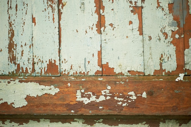 Textuur van oude houten planken met afbladderende verf een hek of een muur van een huis