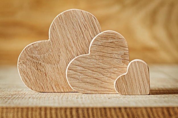 Tgree wooden hearts on wood background